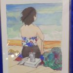 Image Description:[The background is a royal blue tablecloth with a painting made by Tom Posedly of Kailua Beach, Hawaii. The background shows water with colors of light green, blue and white waves, light and medium colored sand, and a white woman sitting in front of the water seen from her back. The woman has short black hair at her neck, a white colored bathing suit with flowers of blue, green, and red, and black swim shorts sitting with her knees to her chest with her arms/hands wrapped around her legs. She is sitting on a beach towel that is white, blue, and red with her yellow colored sandals on the left of her, an open book with white pages behind her and a paper cup with a plastic top and straw on top of the book, and then a beach bag on her right. The words “KAILUA BEACH” are on the bottom left and “POSEDLY” on the bottom right in black.]